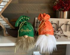 two gnome hats sitting on top of a white shelf next to a red and green bag