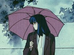 a woman holding an umbrella while standing in the rain with her hand on her hip