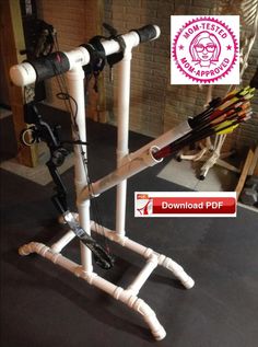 the bow stand is made out of pipes and pipe holders with arrows attached to it