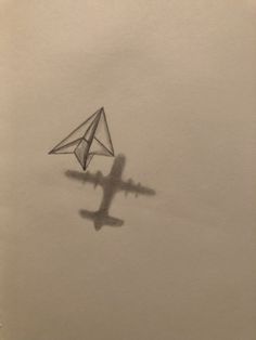 a drawing of a plane flying in the sky with a paper airplane on it's side