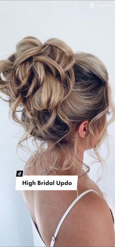 a woman with her hair in a messy updo is looking back at the camera