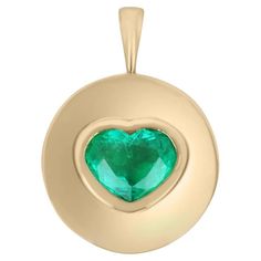 A stunning emerald heart signet pendant. This heart-shaped emerald is from the famous mines of Colombia. The emerald displays a beautiful medium green color and very good luster. The emerald is bezel set in a custom-made golden frame. An 18K cable chain is included with the pendant. Setting Style: Bezel Setting Material: 18K Yellow Gold Setting Weight: 7.7 Grams Main Stone: Emerald Shape: Heart Cut Weight: 2.30-carats Clarity: Transparent Color: Green Luster: Very Good Treatment: Natural, Modera Emerald Style, Tiny Bow, 80th Birthday Gifts, Colombian Emeralds, Bezel Pendant, Emerald Pendant, Yellow Gold Setting, Coin Pendant, Cable Chain