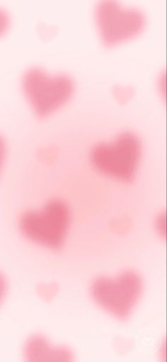 a blurry pink background with hearts on it