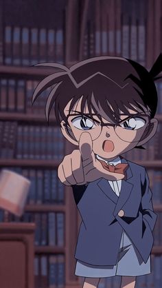 an anime character pointing at the camera in front of a book shelf with books on it