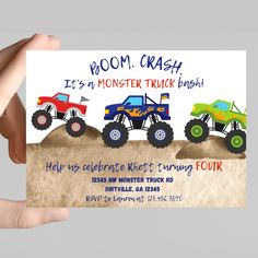 a person holding up a card with monster trucks on it