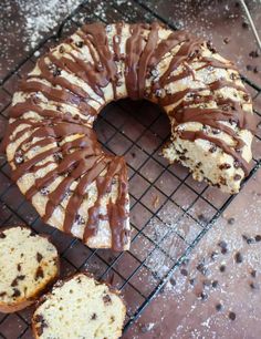 a bundt cake with chocolate drizzled on top and slices cut out