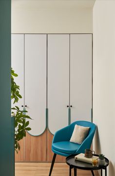 a blue chair sitting in front of a white closet