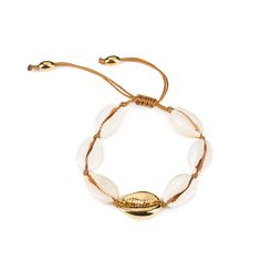 a bracelet with white beads and gold accents