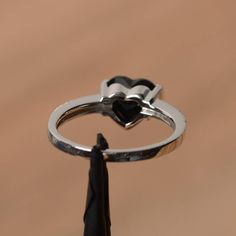 It is a natural black spinel ring. The main stone is 8mm*8mm heart cut, weight about 2.33 carats. The basic metal is sterling silver and plated with rhodium. To change the metal to a solid gold (white/rose) or platinum is also available, please ask for a quotation if you want. You can also go to my shop Home for more elegant rings: https://www.etsy.com/shop/godjewelry?ref=hdr_shop_menu More black spinel rings: https://www.etsy.com/shop/godjewelry/items?ref=seller-platform-mcnav&section_id=21 Spinel Rings, Elegant Rings, Black Spinel Ring, Spinel Ring, Ring Heart, Black Spinel, Proposal Ring, Elegant Ring, White Rose