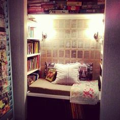 a small room with a bed and bookshelf