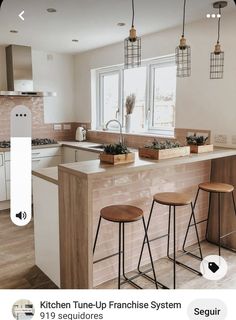 three stools sit at the center of a kitchen island