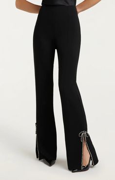 Black Rhinestone Bow Kali Pant Feel your most glamorous in the Rhinestone Bow Kali Pant. These full-length pants provide a comfortable fit with their high waist and drapey crepe material. With side slits and an embellished bow detail, you'll shine in any room. Feel confident and beautiful in this statement-making style. Crepe Material, Denim Chic, Rhinestone Bow, Parisian Chic, Black Rhinestone, Ladies Boutique, Bow Detail, Invisible Zipper, Feel Confident