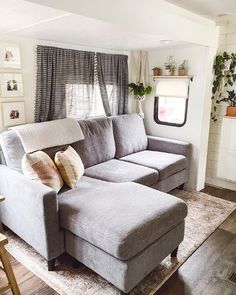 a living room filled with furniture and a large rug on the floor in front of a window