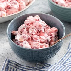 two bowls filled with food on top of a table