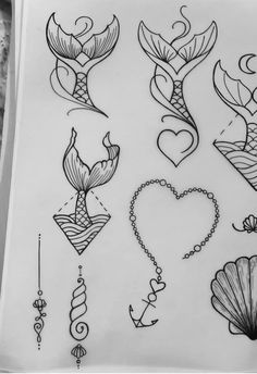 some tattoos are drawn on paper and have been placed in the shape of mermaids