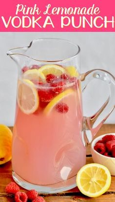 pink lemonade vodka punch in a pitcher with raspberries and lemons on the side