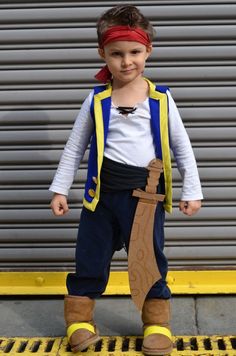 a young boy dressed up in pirate costume