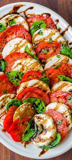 grilled tomatoes and mozzarella with balsami dressing on a white platter