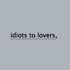 the words idiotots to lovers, are in black and white on a gray background