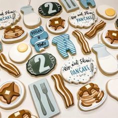 decorated cookies are arranged in the shape of baby's first birthdays and other items