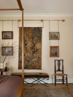 a bedroom with a canopy bed and pictures on the wall