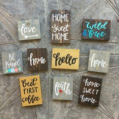 six hand painted wooden signs on the side of a stone wall that say home, sweet home, eat first coffee, and be kind of hope