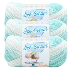 three skeins of ice cream yarn in light blue, white and yellow colors