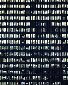 an office building with many windows lit up at night