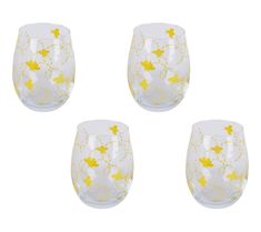 four glasses with yellow flowers on them are sitting in the middle of a white background