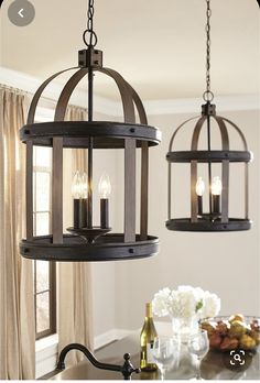 two chandeliers hanging from the ceiling in a kitchen