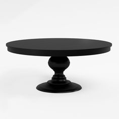 a black round table sitting on top of a white floor