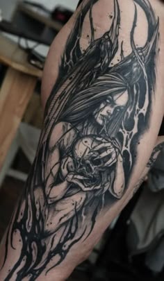 a black and white tattoo on the leg of a person with an evil demon face