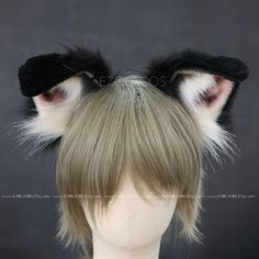 a wig with black and white fur on it's ears is shown in front of a gray background