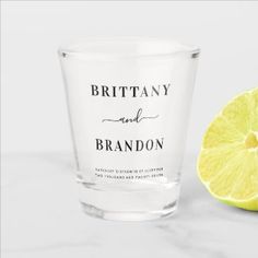 a shot glass with the words eat drink and be married next to a lemon