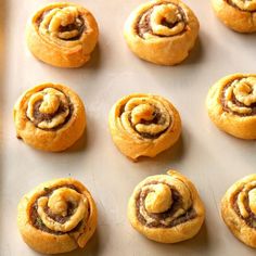 many small pastries are on a baking sheet and ready to go into the oven