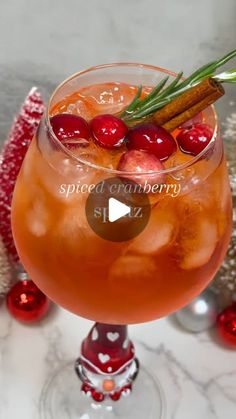 an image of a drink in a glass with cinnamon and cherries on the rim