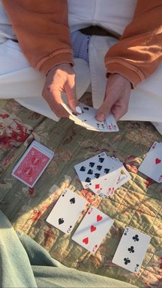 someone is playing cards on the bed