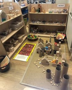 a room filled with lots of different items on top of a wooden floor next to shelves