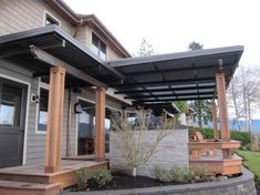 a house with an attached patio and stone wall