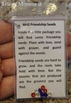 a hand holding a piece of paper with beads on it and a poem about the benefits of seeds