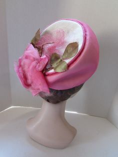 "SALE! 10% OFF! Striking Mid Century Hat in Peony Pink Chiffon. We will call this a modified bubble style, as it soars at front, but flattens at the back. Marche Exclusive designed this in a union shop. The peony pink chiffon covers white millinery straw. At the back of the crown poses the 6\" pink rose. Net covers all. See condition report below. In mid century style, this would be worn toward the top of the head, not at the forehead Size: 4 1/2\" tall at front to 1/2\" at the back; 6 1/4\" acr Retro Pink Brimmed Hat, Pink Cloche Hat For Kentucky Derby, Pink Fitted Cap Mini Hat, Retro Pink Wide Brim Hat, Pink Spring Bonnet Cap, Pink Bonnet For Spring, Vintage Fitted Bonnet For Spring, Elegant Adjustable Pink Bonnet, Pink Retro Party Hats