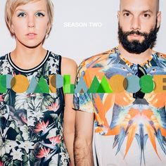 two people standing next to each other in front of a white wall with the word aooa on it