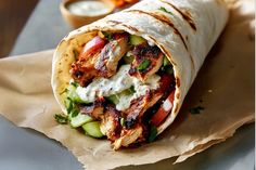 a burrito with chicken, cucumber and ranch dressing