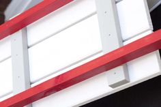 a red and white ladder attached to the side of a building