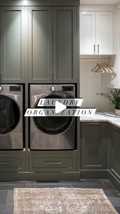 a laundry room with two washers and dryer next to each other in front of cabinets