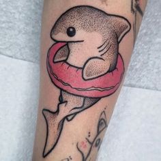 a shark with a life preserver tattoo on his leg is seen in this image