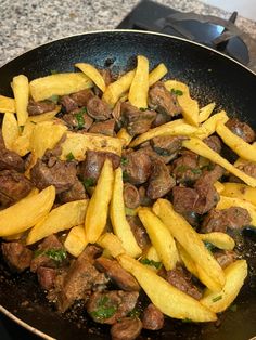 some food is cooking in a frying pan on the stove top and ready to be cooked