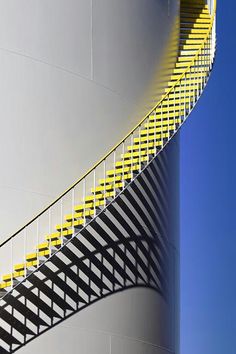 the stairs are painted yellow and white to match the building's modern architecture style