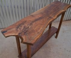 a wooden bench sitting on top of a cement floor