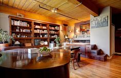 a dining room table with fruit on it in front of bookshelves and shelves